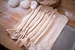 A bag of dough on a table with a rolling pin photo