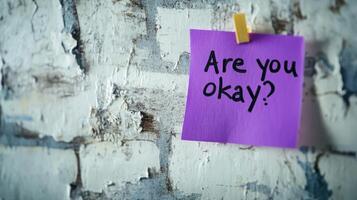 Sticky note with a comforting message affixed to a textured wall expressing concern for someone's well-being in a home or office setting photo