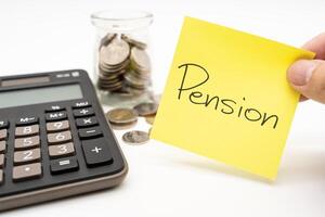 PENSION text on sticky note with Calculator. Thai Baht Coins spilled out of jar glass isolated on white background, saving for future, Retirement concept. photo