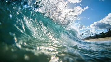 The waves gently crash onto the shore of a sun-drenched beach photo