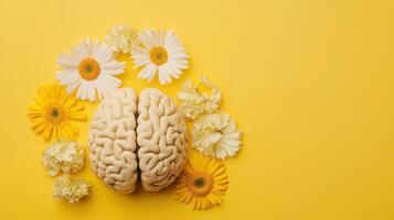 A vibrant brain encircled by a stunning array of colorful flowers rests against a cheerful yellow backdrop on a sunny afternoon photo