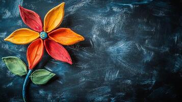 Colorful clay flower crafted against a dark background showcases artistic creativity and vibrant expression in a unique design photo