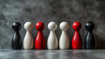 Colorful wooden figures lined up against a textured gray background, showcasing diverse shapes and colors during a creative display photo