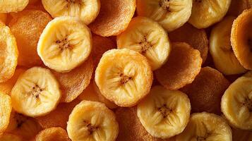 Dried banana chips spread across a surface showcasing their vibrant yellow color and crispy texture in a natural light setting photo