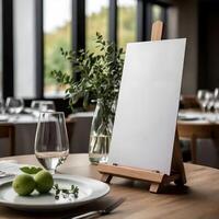 A white easel with a blank canvas on a table photo