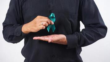 Man holding green awareness ribbon isolated on white background photo