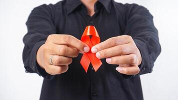 Man holding red awareness ribbon isolated on white background photo