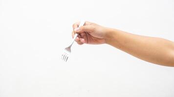 Hand Holding Stainless Steel Fork Isolated on White Background photo