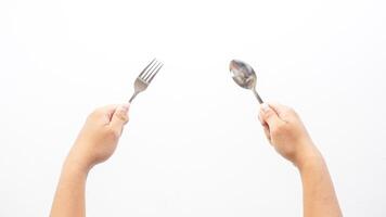 Hands of Man Holding Spoon and Fork Isolated on White Background photo