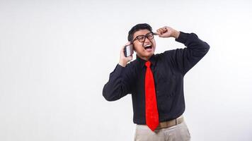 Portrait of Asian employee business man corporate wearing formal clothes talking on the phone call with annoyed face isolated on white background photo