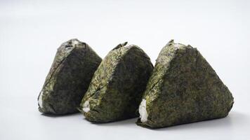 Three Japanese rice ball wrapped in nori dried seaweed or onigiri on isolated on white background photo