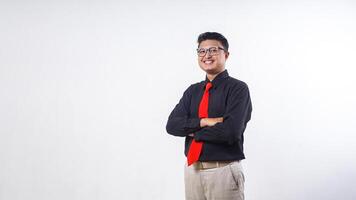 Happy Asian man wearing formal clothes smiling at camera with arm crossed isolated over gray background photo
