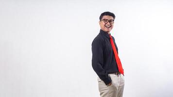 Side view of happy Asian man wearing formal clothes smiling at camera with hands in pockets isolated on white background photo