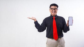 Smiling Asian employee business man corporate wearing formal clothes holding mobile cell phone with blank screen mock up for advertisement isolated on white background photo