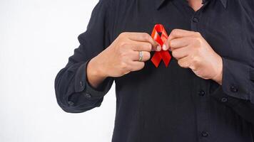 Man holding red awareness ribbon to support people living with HIV AIDS isolated on white background photo