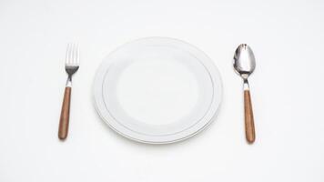 Wooden Handle Spoon, Fork, and Plate Isolated on White Background photo