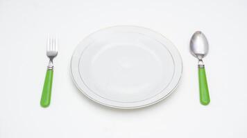 Classic Spoon, Fork, and Plate Isolated on White Background photo