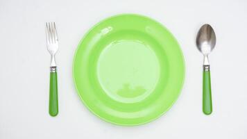 Simple Spoon, Fork, and Plate Isolated on White Background photo