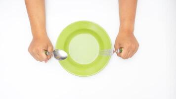 Hand with Plate with Spoon and Fork Isolated on White Background photo