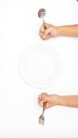 Hand with Silverware and Plate Isolated on White Background photo