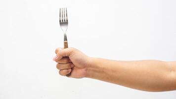 Male Hand Holding Stainless Steel Fork with Wooden Handle Isolated on White Background photo