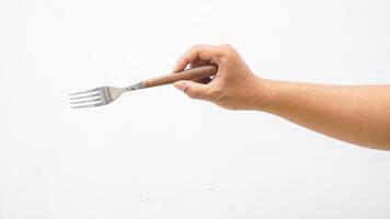 Hand of Man Holding Stainless Steel Fork with Wooden Handle Isolated on White Background photo