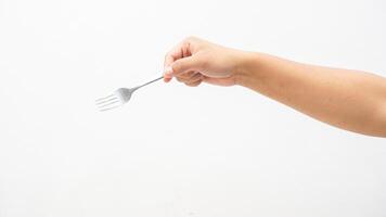 Hand Holding Silver Stainless Fork Isolated on White Background photo