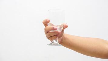 Hand of Man Holding Transparent Glass Isolated on White Background photo