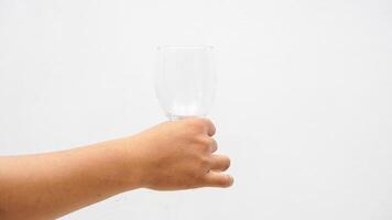 Hand Holding Empty Glass Isolated on White Background photo