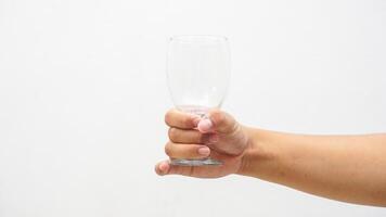 Hand of Man Holding Empty Glass Isolated on White Background photo