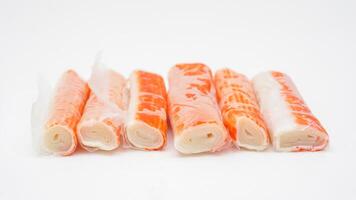 Uncooked crab stick or imitation crab meat made from processed fish isolated on white background photo