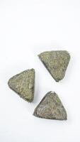 Top view of Japanese onigiri made from savory rice in triangular shaped wrapped in nori or seaweed isolated on white background photo