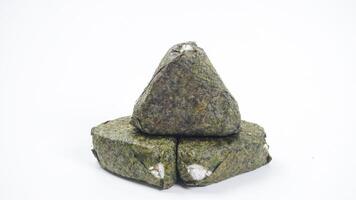 Delicious Japanese onigiri made from savory rice in triangular shaped wrapped in nori or seaweed isolated on white background photo