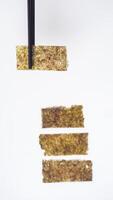 Chopsticks Picking Up Nori Seaweed Isolated on White Background photo