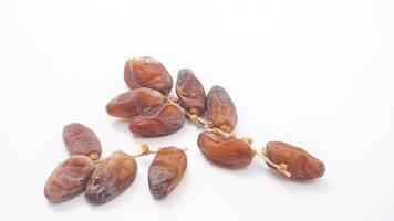 Sweet Dried Dates Fruit on Stalk for Ramadan Iftar Isolated on White Background photo