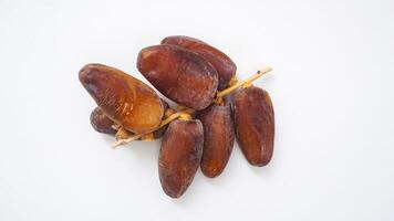Dried Dates Fruit on Stalk Isolated on White Background photo
