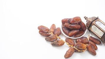 A Bowl of Soft Dates Fruit Sweet and Juicy Isolated on White Background photo