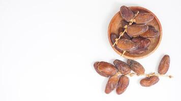 A Plate of Soft and Chewy Dates Fruit for Iftar Isolated on White Background photo