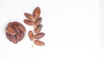 A Bowl of Delicious Ripe Dates Fruit Nutritious Iftar Treat Isolated on White Background photo