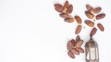 Fresh Sweet Dried Dates Fruit on Stalk Nutritious Iftar Snack Isolated on White Background photo