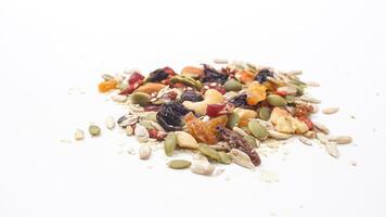 Crunchy nuts seeds and dried fruits assortment isolated on white background photo