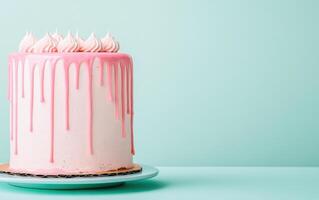Delicious homemade cake with pink dripping glaze, beautifully presented against mint green background, perfect for celebrations and special occasions photo