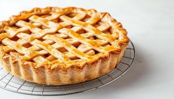 Freshly baked rustic apple pie with golden lattice crust cooling on wire rack, showcasing its delicious filling and flaky texture. Perfect for dessert lovers photo
