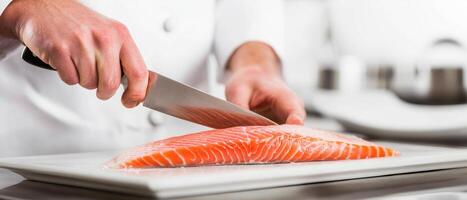 Slicing fresh fish fillets, chef skillfully prepares meal in modern kitchen. vibrant colors of salmon highlight artistry of culinary techniques photo