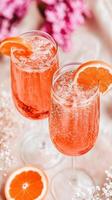 Refreshing summer drinks in clear glass cups with fresh citrus slices. vibrant colors and bubbles create joyful atmosphere, perfect for warm days photo