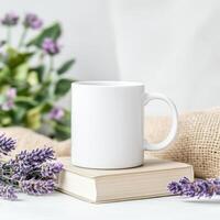 bright white mug placed on stack of books, surrounded by lavender flowers, creating serene and cozy atmosphere. Perfect for enjoying warm beverage photo