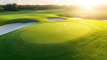 stunning aerial view of golf course showcasing well maintained green with flag, surrounded by sand traps and lush grass, illuminated by warm glow of setting sun photo