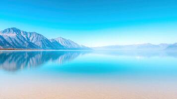 serene lake reflects majestic mountains under clear blue sky, creating tranquil and peaceful atmosphere. calm water enhances beauty of landscape, inviting relaxation and contemplation photo