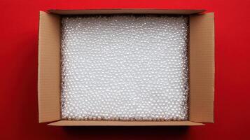 cardboard box filled with bubble wrap sits vibrant red background, showcasing importance of packaging logistics and supply chain solutions. This highlights role of protective materials ensuring photo