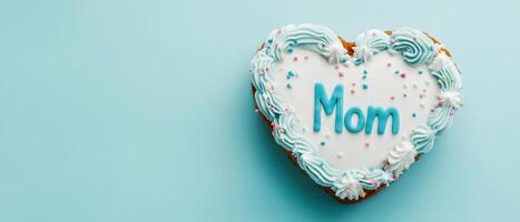 heart shaped cake decorated with blue icing and colorful sprinkles celebrates love for mothers on this special day photo